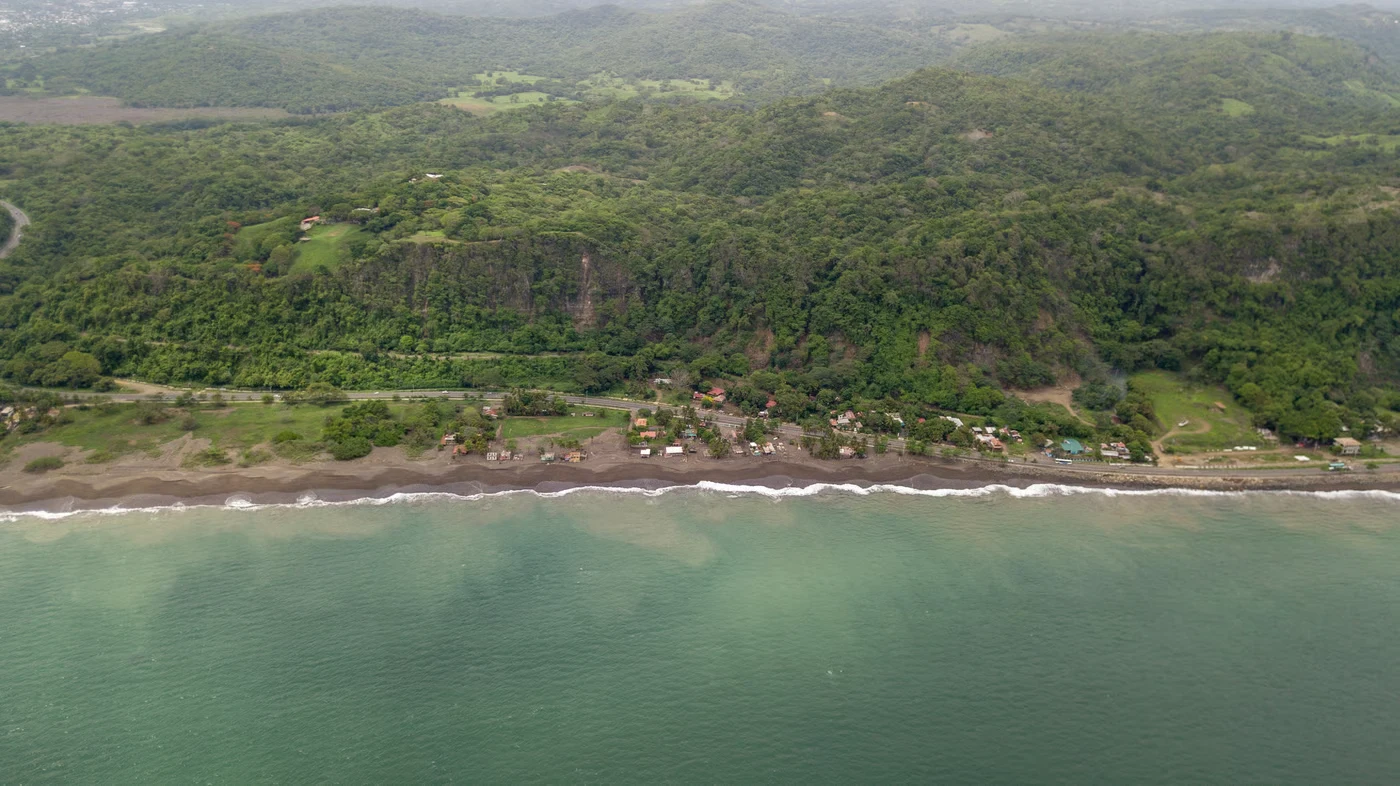 Aerial view of a Costa Rican coastline and green mountains